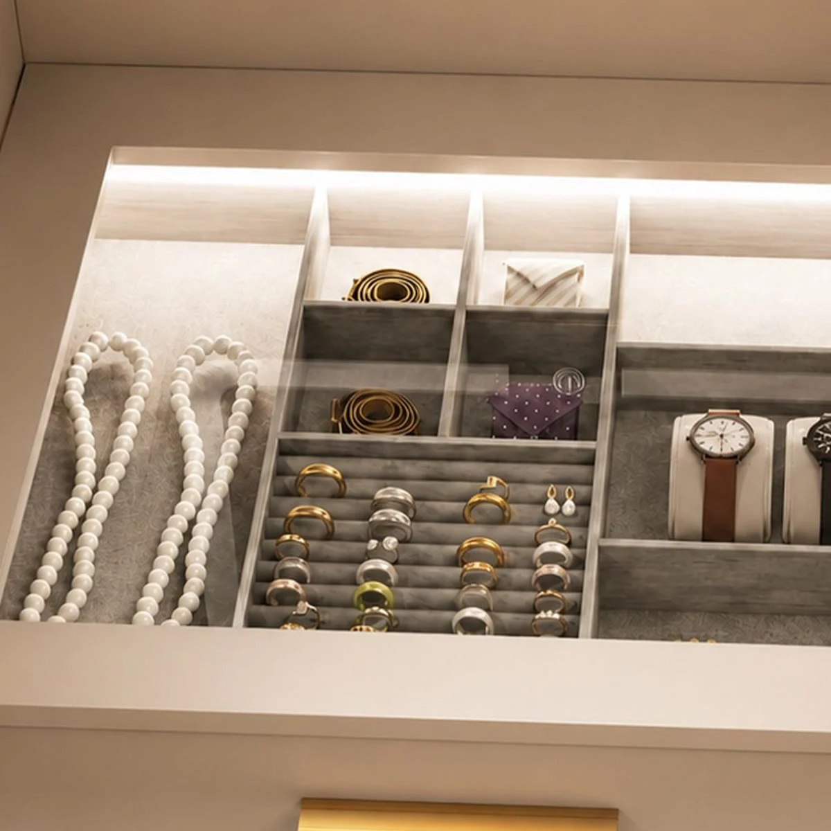Anillos, collares y relojes guardados bajo la encimera de cristal iluminada del tocador